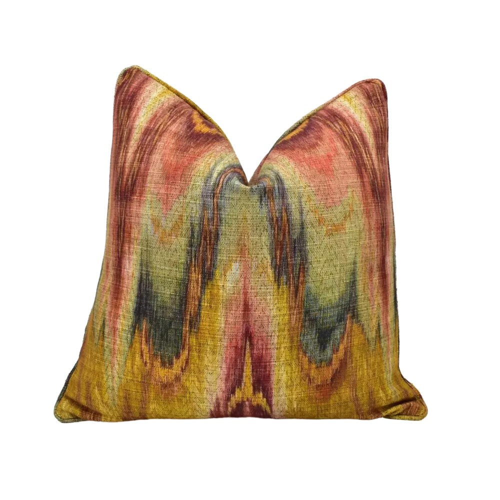 a vibrant, abstract patterned pillow with a mix of warm colors, including shades of red, orange, yellow, and green. The design appears to be a swirling or abstract pattern, creating a visually striking and eye-catching piece.