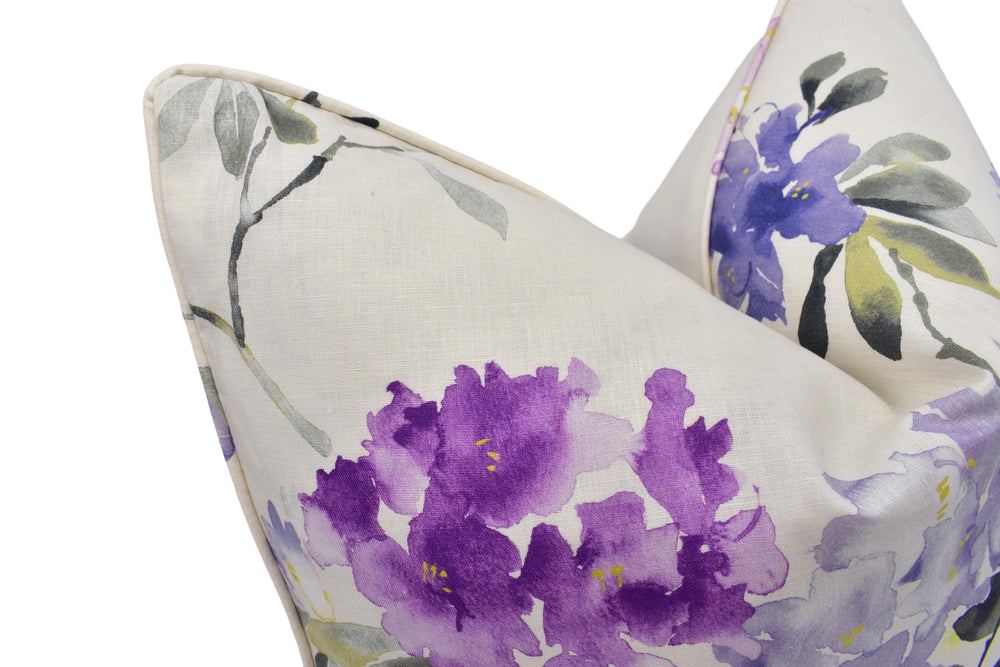 a white pillow with purple flowers on it