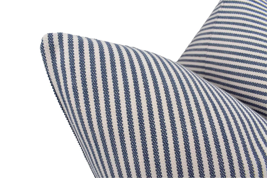 a close-up view of a striped pillow with a blue and white pattern.