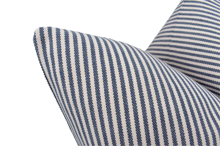a close-up view of a striped pillow with a blue and white pattern.