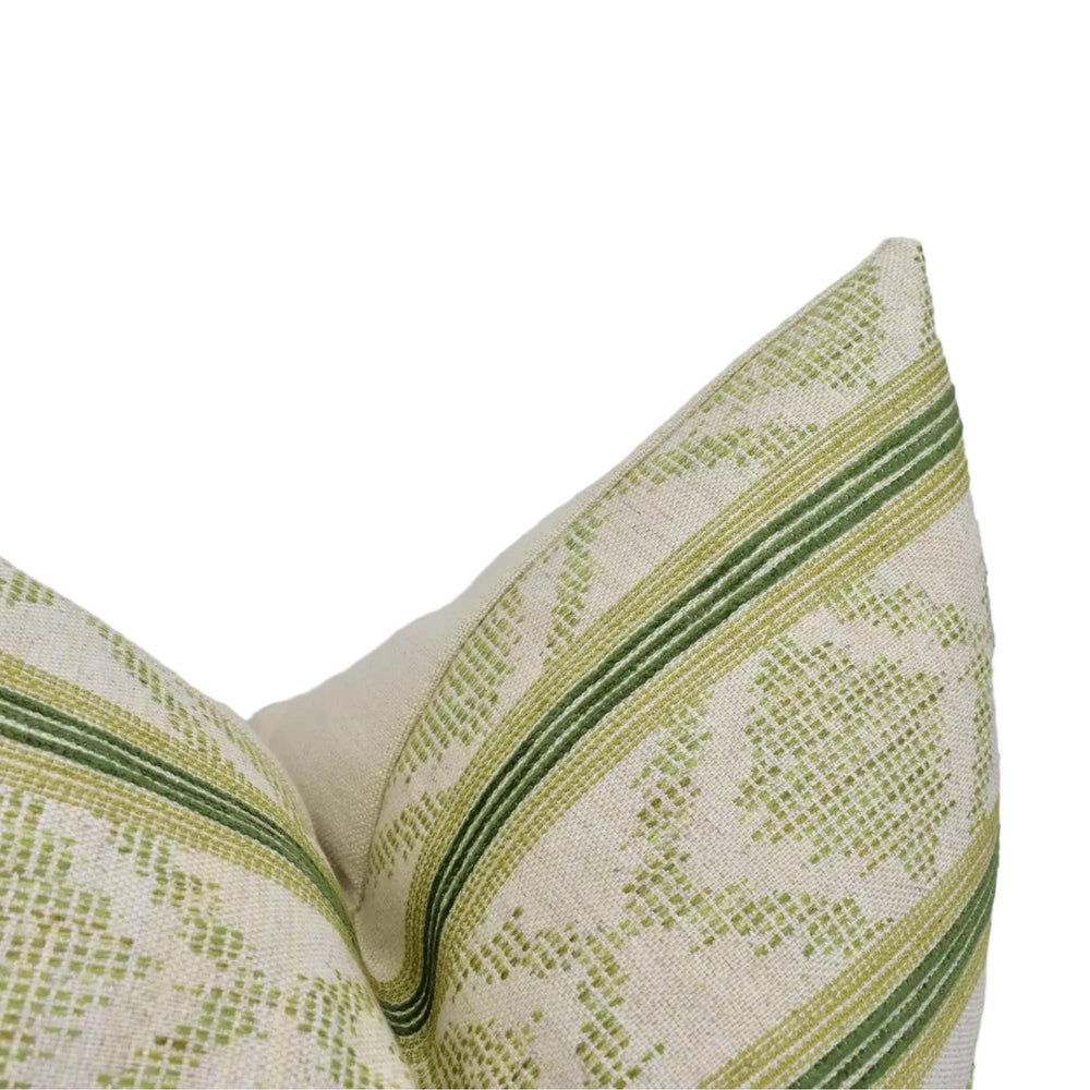 A close-up view of a decorative pillow with a green and white striped pattern.