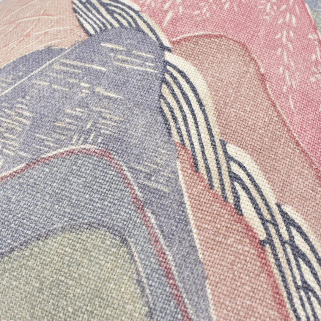 The image is a close-up of a textured fabric with a colorful abstract pattern. The fabric appears to be a blend of various shades of pink, blue, and gray, creating a visually striking and intricate design.