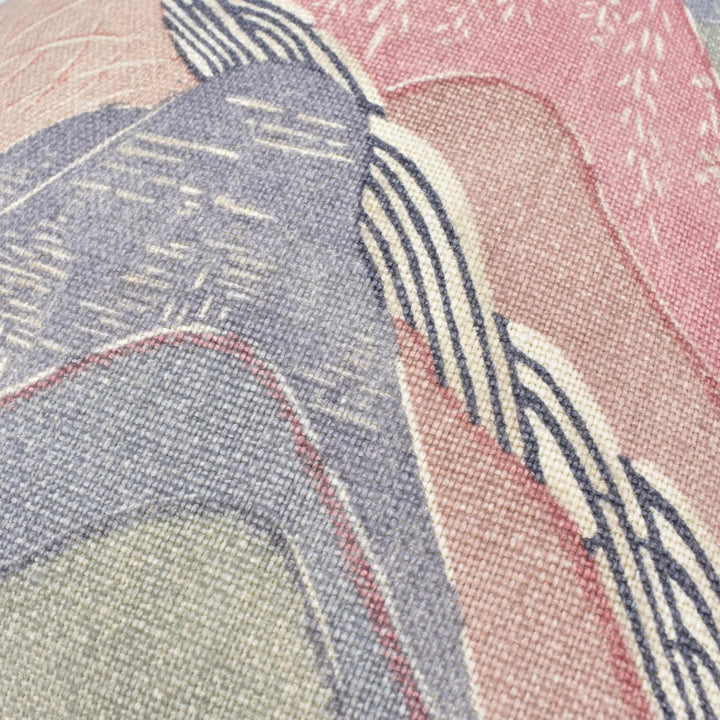 The image is a close-up of a textured fabric with a colorful abstract pattern. The fabric appears to be a blend of various shades of pink, blue, and gray, creating a visually striking and intricate design.