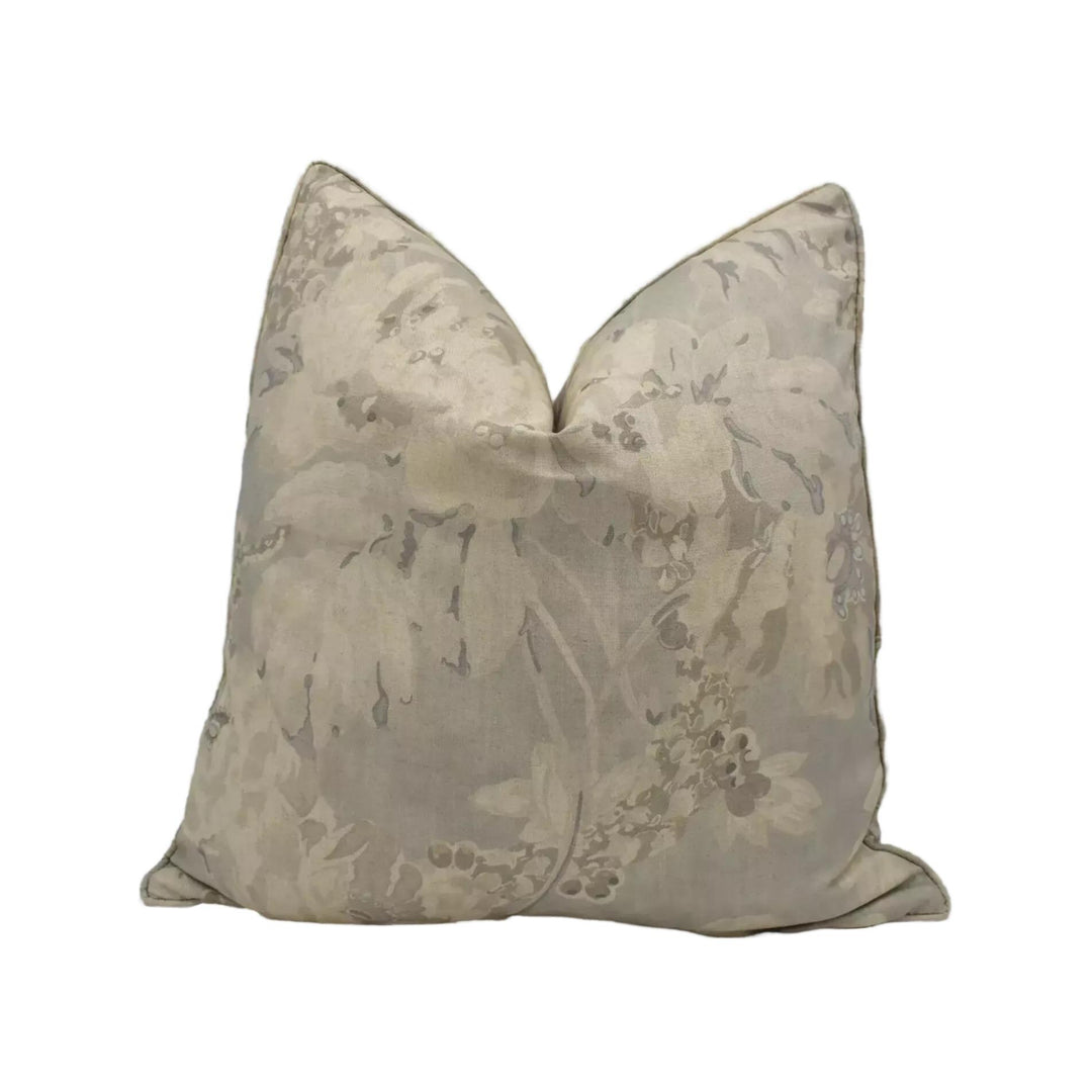 A decorative throw pillow with a floral pattern in shades of gray and beige.