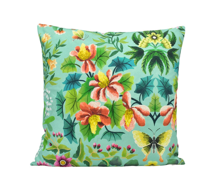 a blue pillow with flowers and butterflies on it