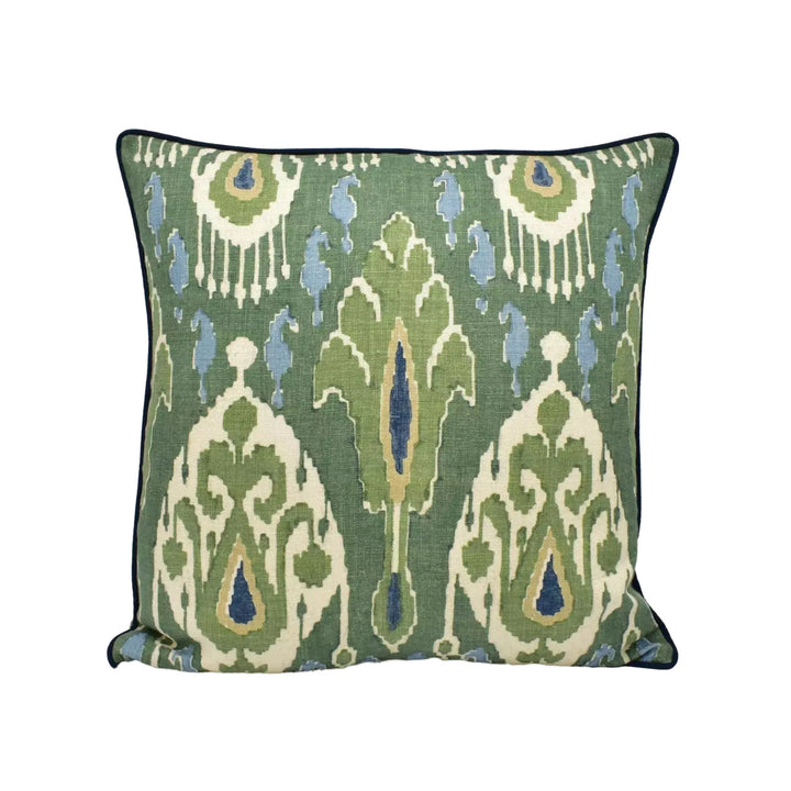 A square throw pillow with a green and white pattern featuring a repeating design of leaves and flowers.