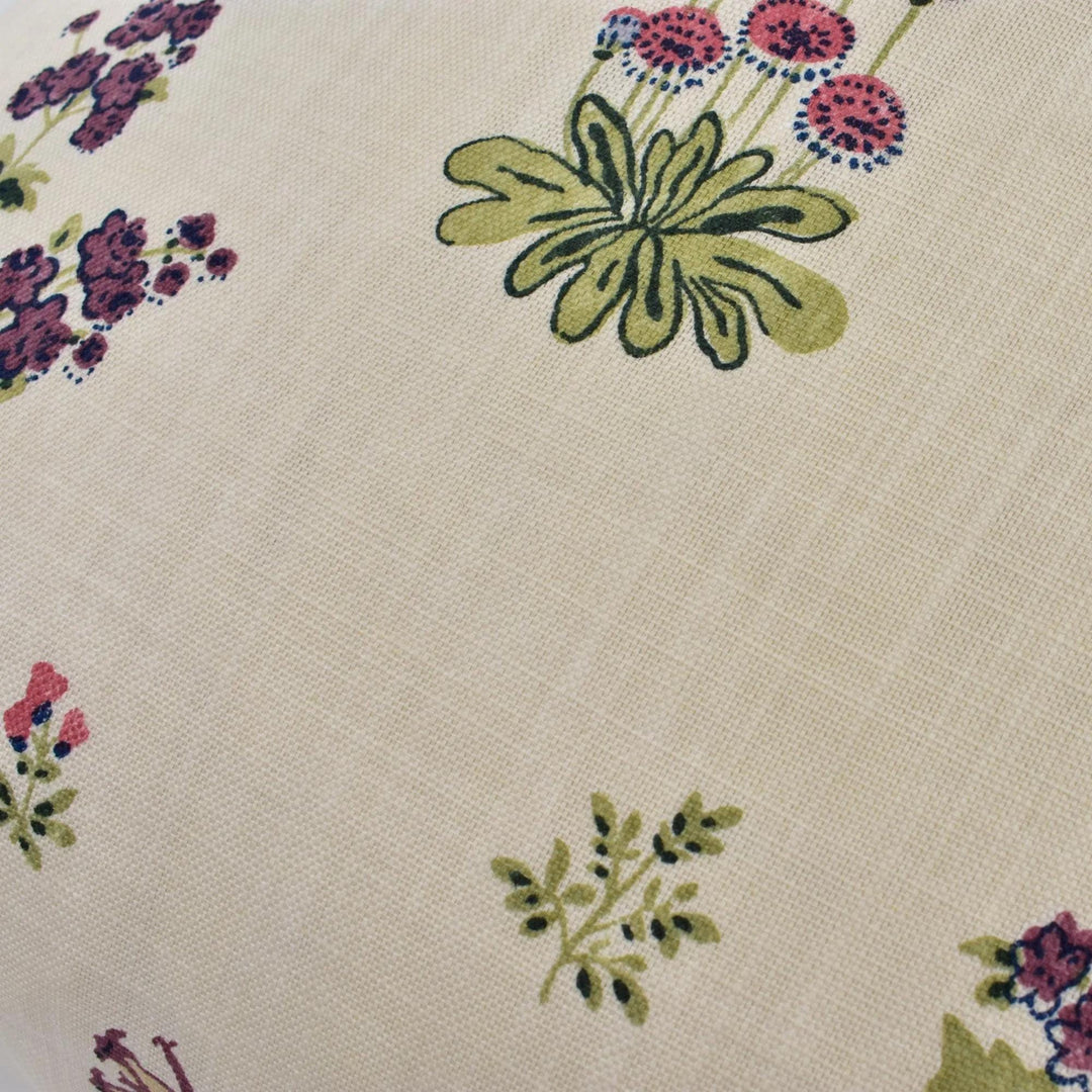 a close-up view of a fabric with a floral pattern, featuring various types of flowers and leaves in different colors.