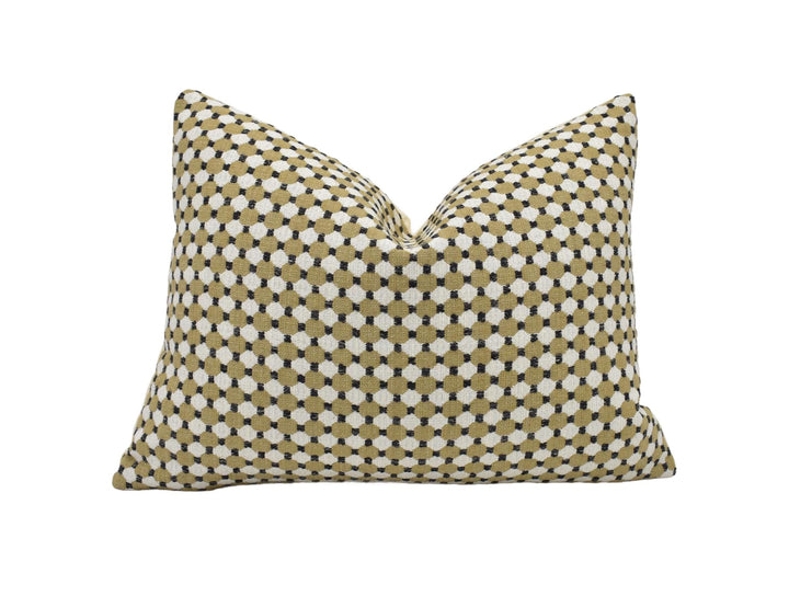 A single pillow with a geometric pattern of small white and beige dots.