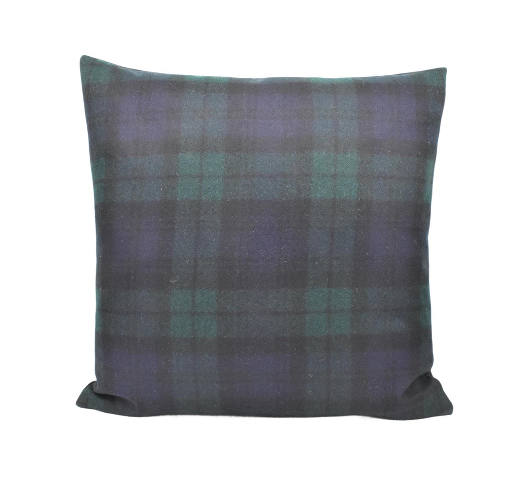 a black and green plaid pillow on a white background