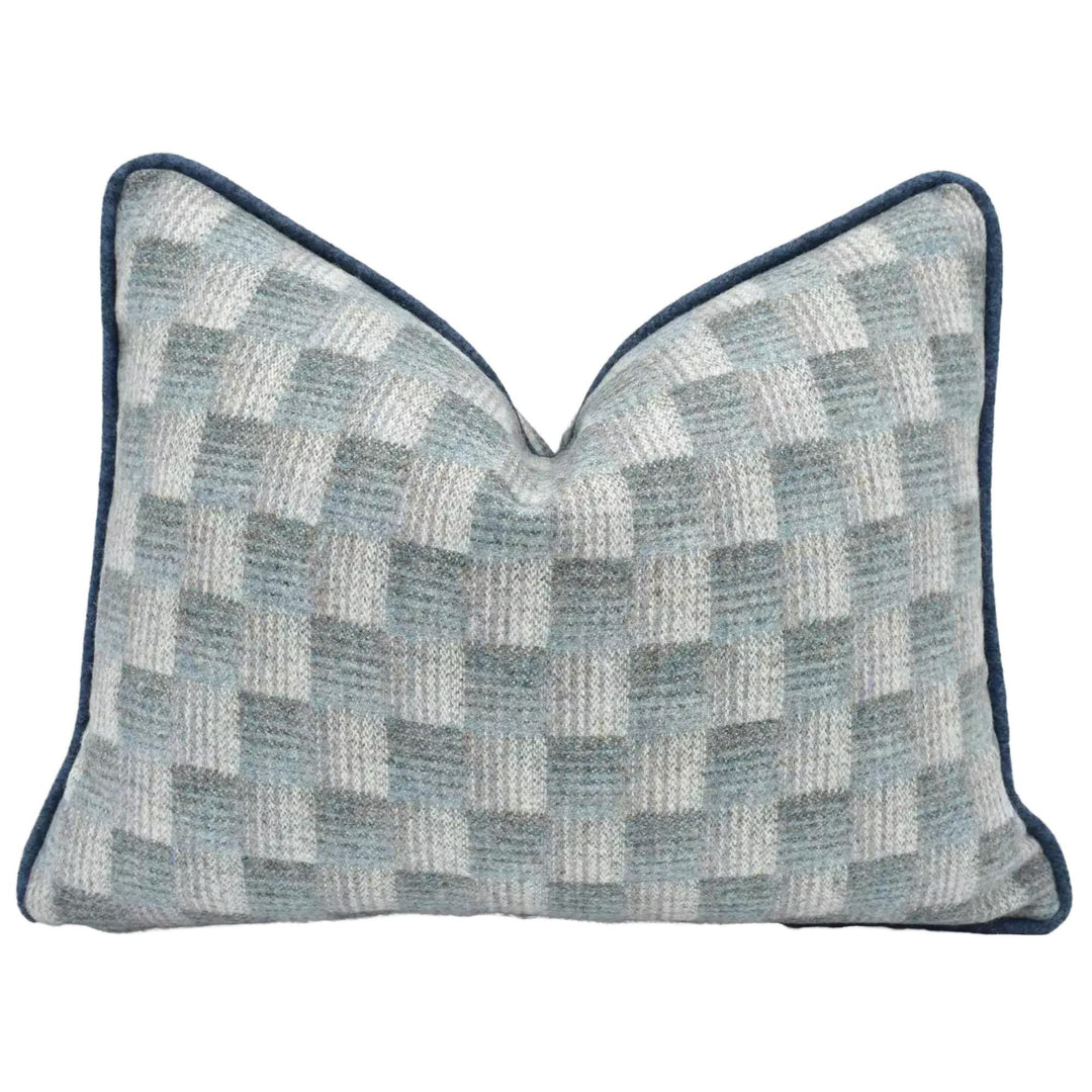 A gray and white checkered pattern pillow with a dark blue border.