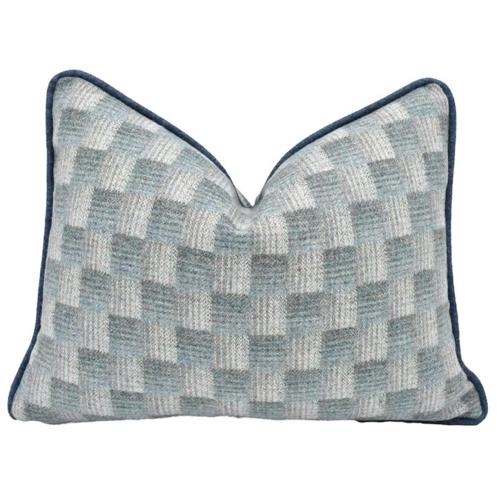 A gray and white checkered pattern pillow with a dark blue border.
