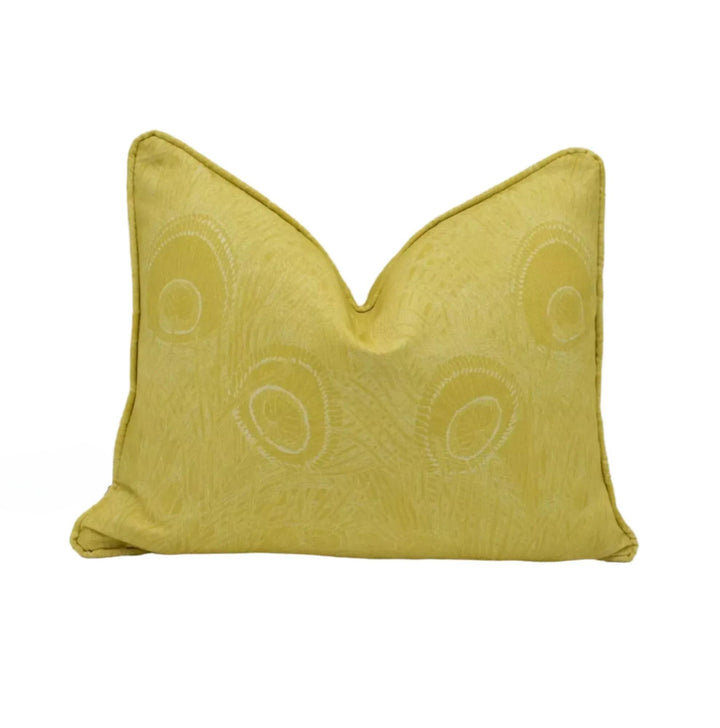 A yellow decorative pillow with a repeating pattern of circles or ovals on it.