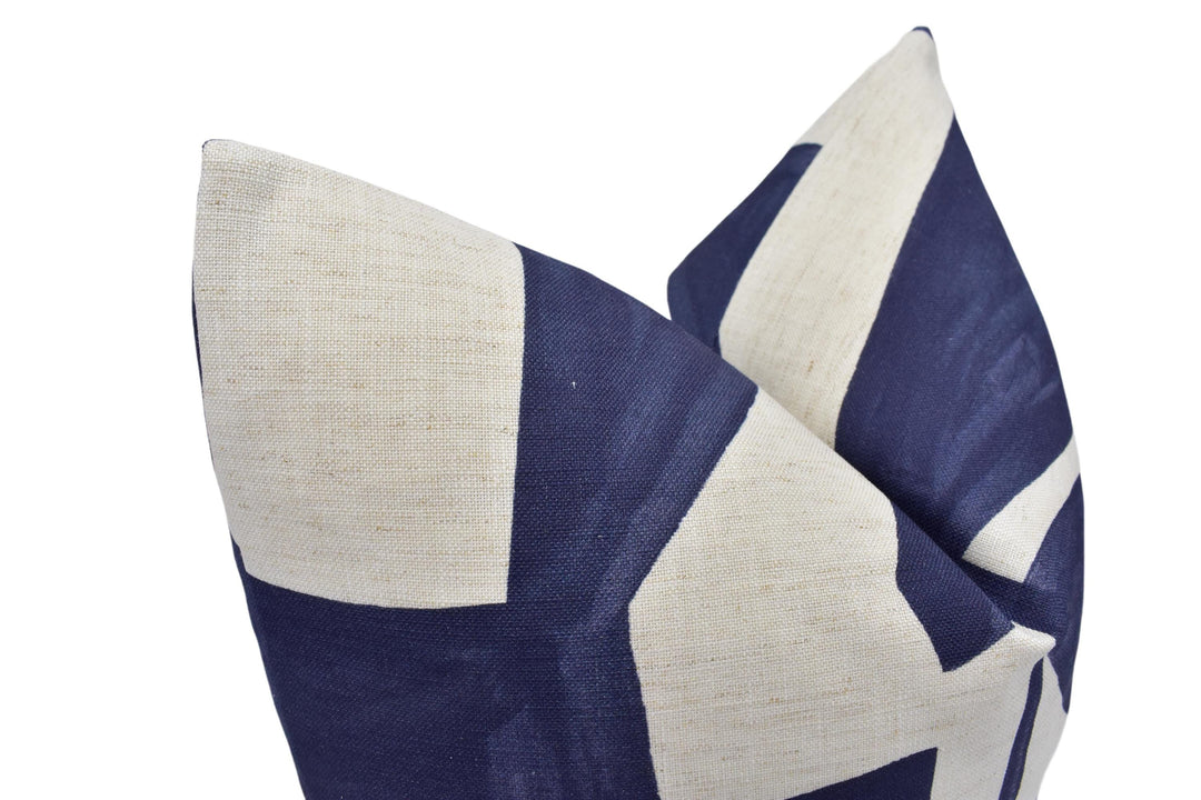 a close up of a blue and white pillow on a white background