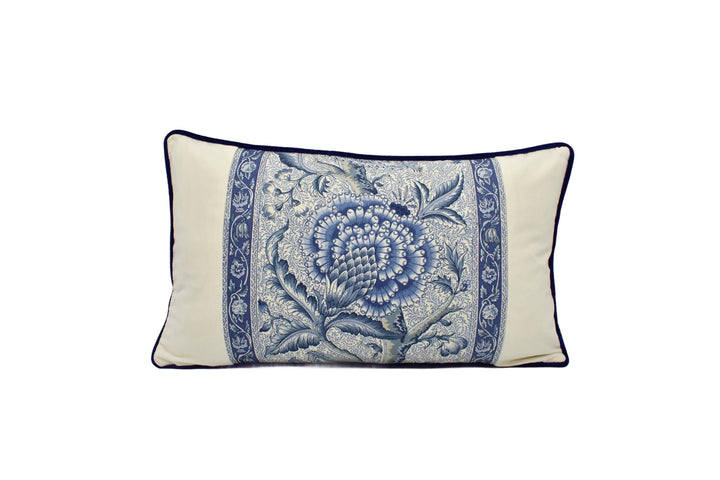 A decorative throw pillow with a blue and white floral pattern.