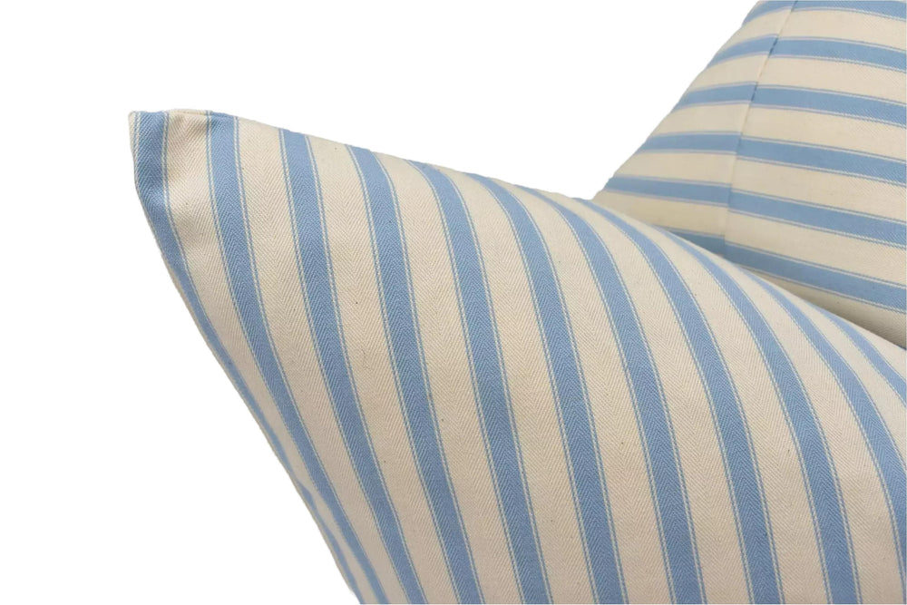 A close-up view of a pillow with blue and white striped fabric, featuring a pattern of vertical stripes.