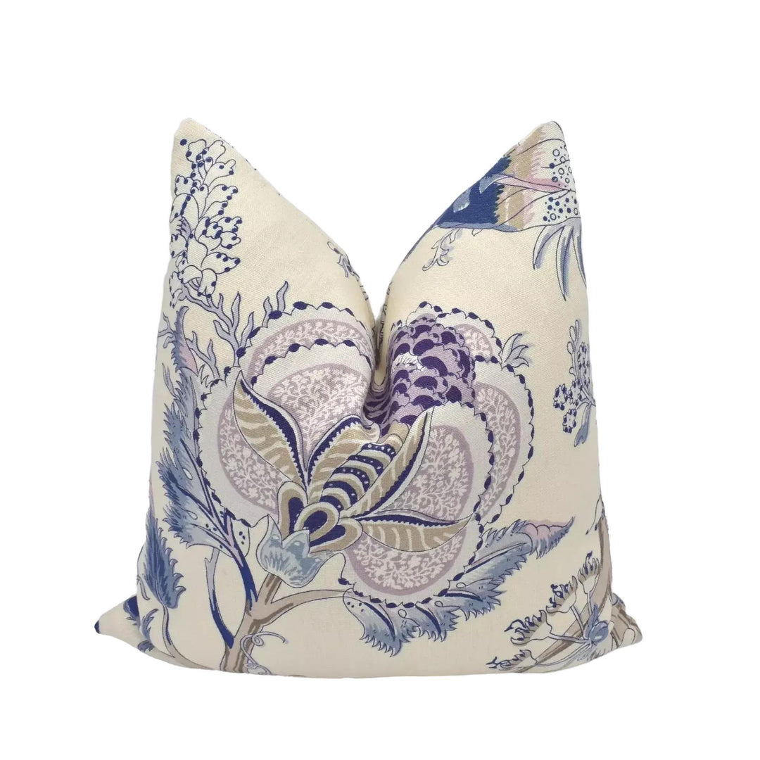 A decorative pillow with a floral pattern in shades of blue and purple.