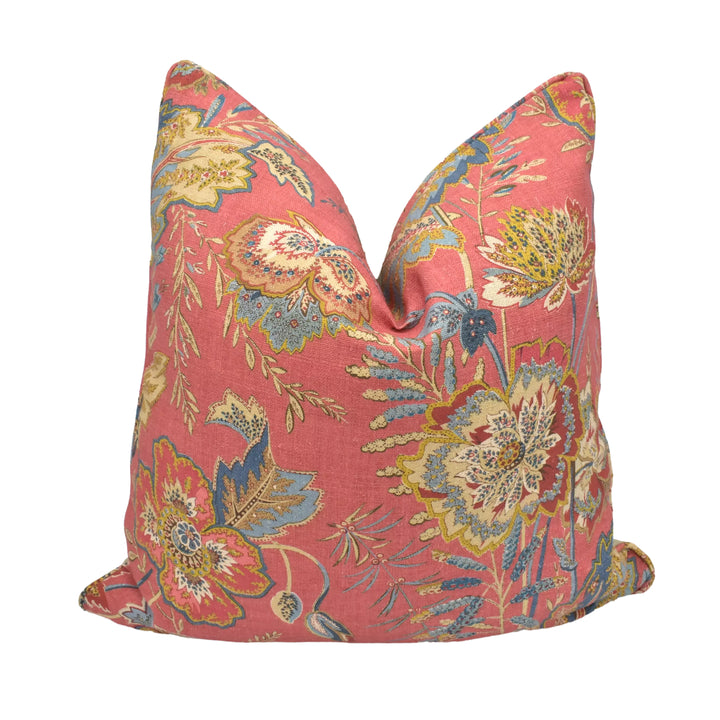A vibrant, floral-patterned red pillow is displayed against a white background.