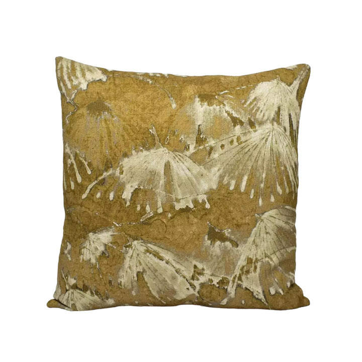 A square throw pillow with a gold and white leaf pattern.