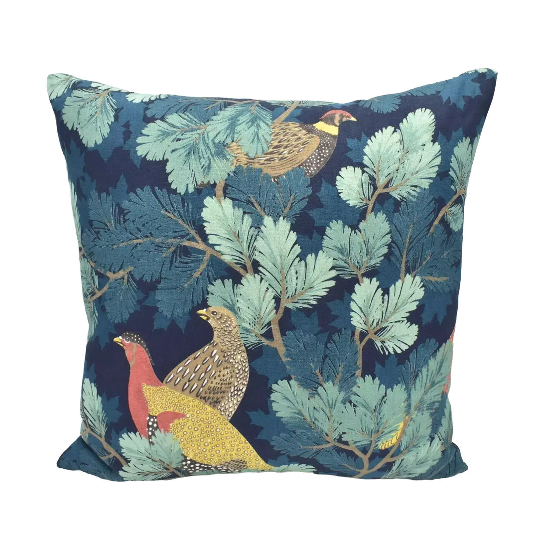 A decorative throw pillow with a vibrant, nature-inspired pattern of birds and foliage in shades of blue, green, and yellow.