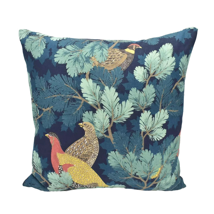 A decorative throw pillow with a vibrant, nature-inspired pattern of birds and foliage in shades of blue, green, and yellow.