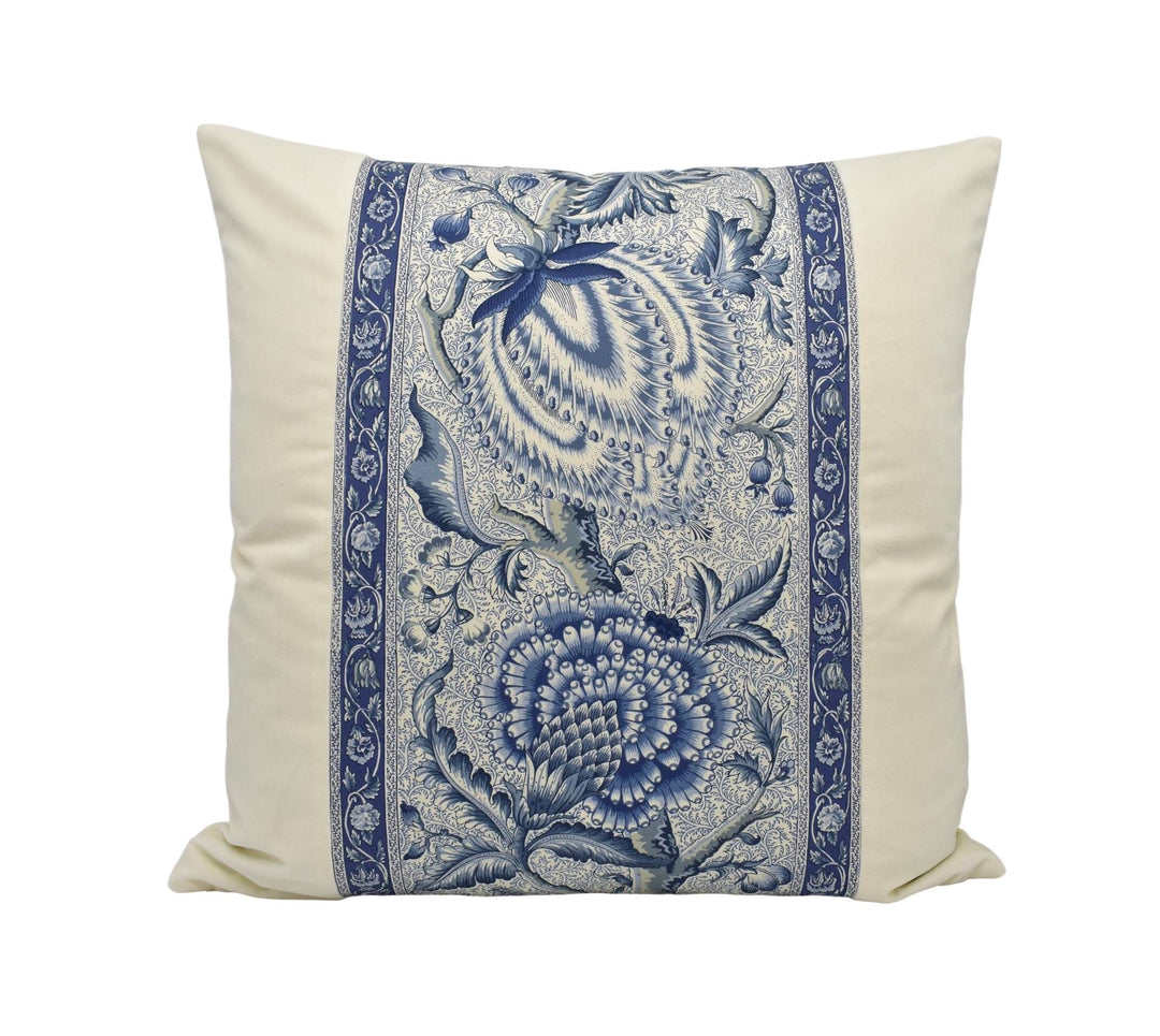 A decorative throw pillow with a blue and white floral pattern.