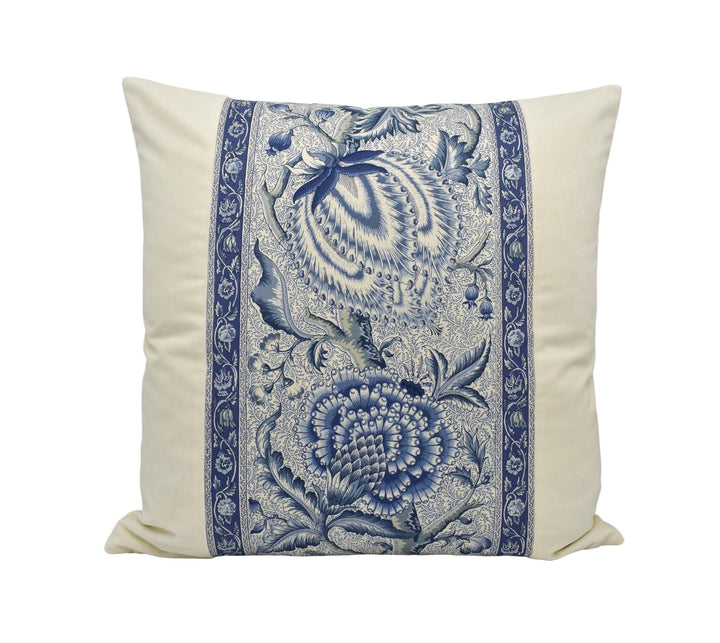 A decorative throw pillow with a blue and white floral pattern.