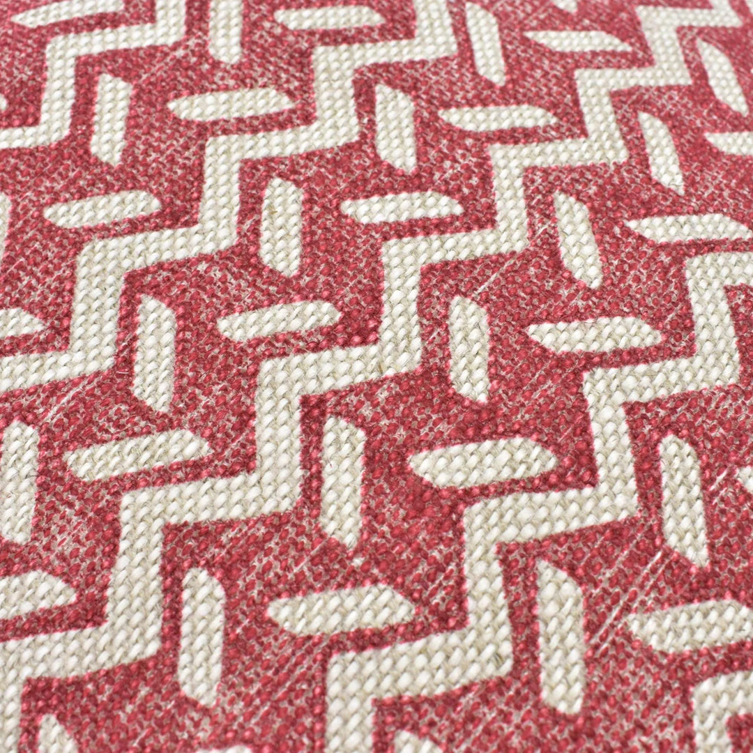 a close-up view of a red and white zigzag pattern on a fabric surface.