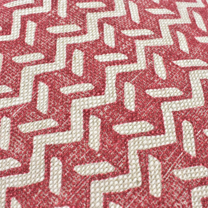 a close-up view of a red and white zigzag pattern on a fabric surface.
