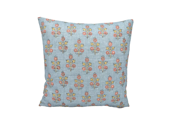 A square throw pillow with a floral print in shades of blue and yellow.
