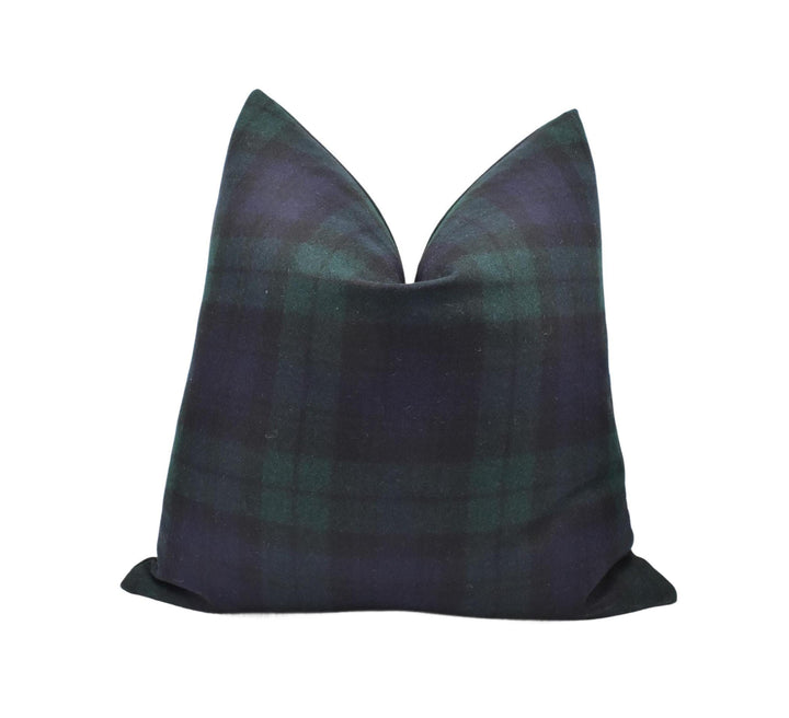 a black and green plaid pillow on a white background