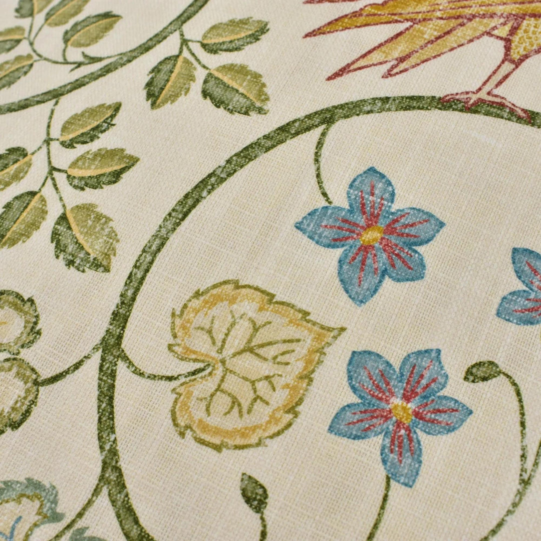 a close-up view of a fabric with a floral pattern, including leaves, flowers, and a bird.