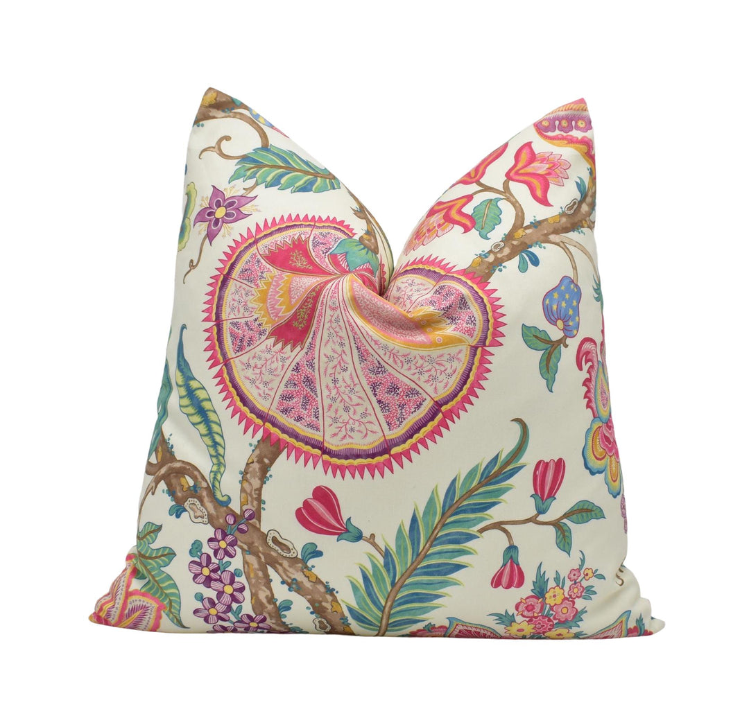 a white pillow with a colorful floral design on it