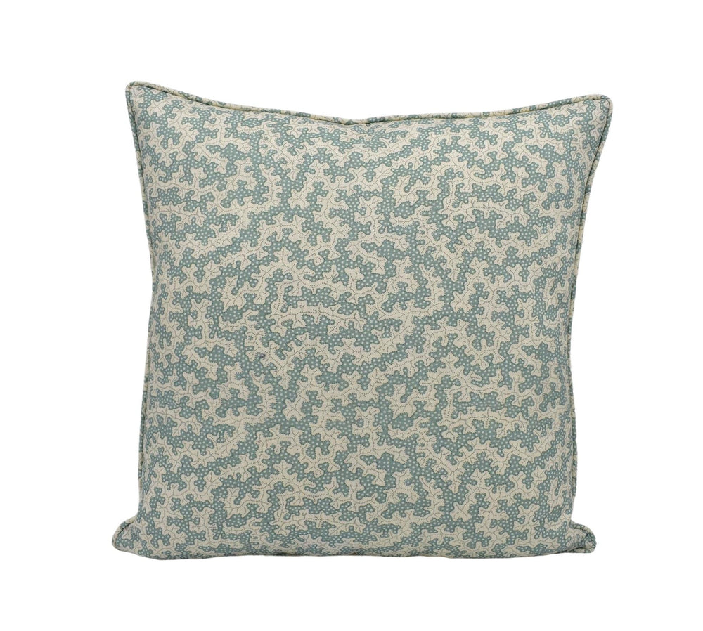A square throw pillow with a pattern of small green and beige flowers or leaves.