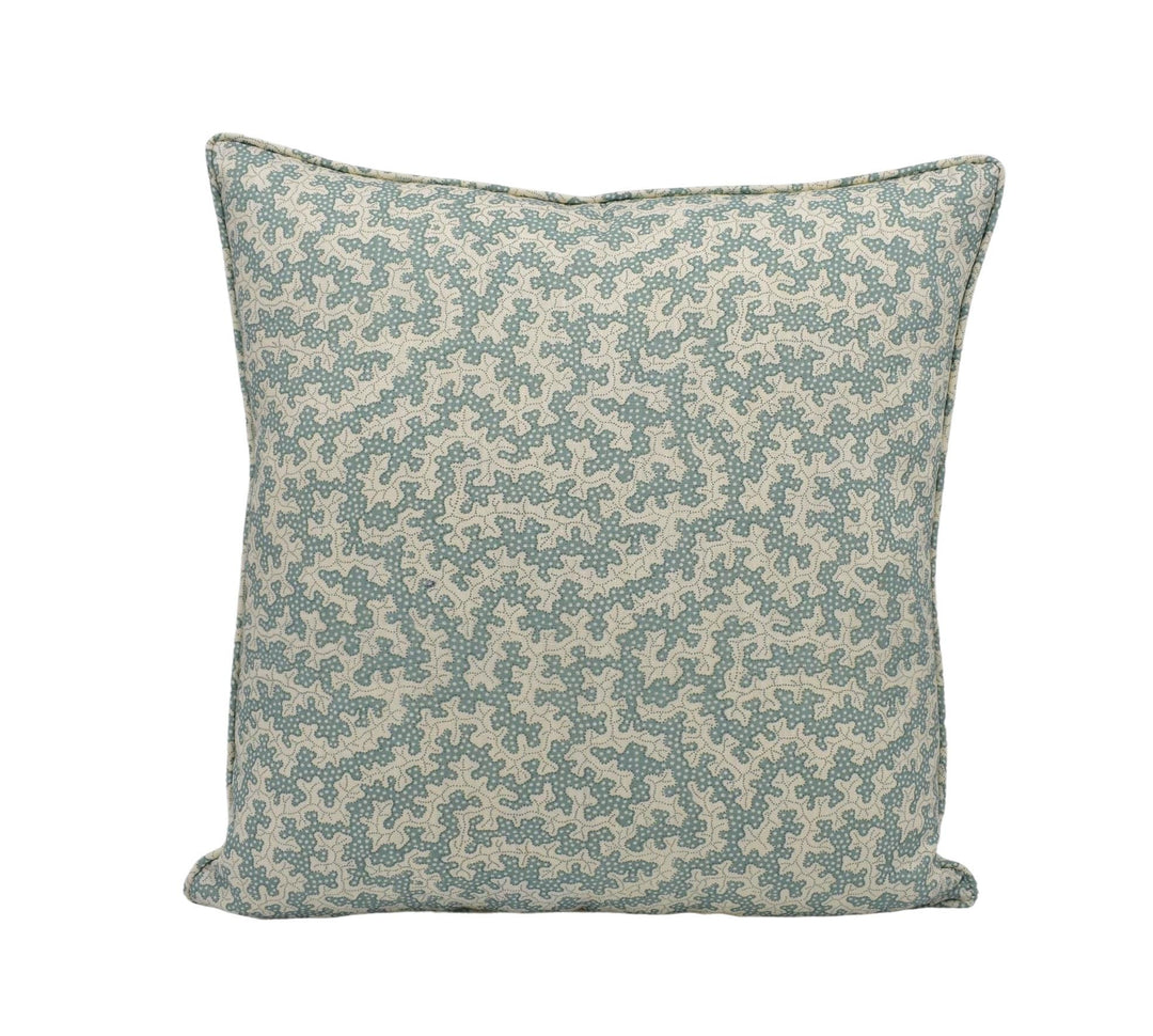 A square throw pillow with a pattern of small green and beige flowers or leaves.