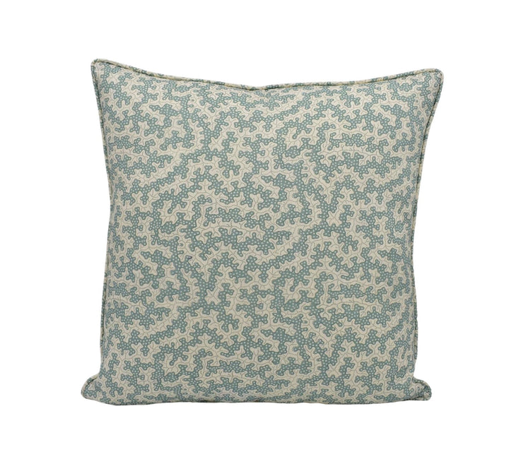 A square throw pillow with a pattern of small green and beige flowers or leaves.