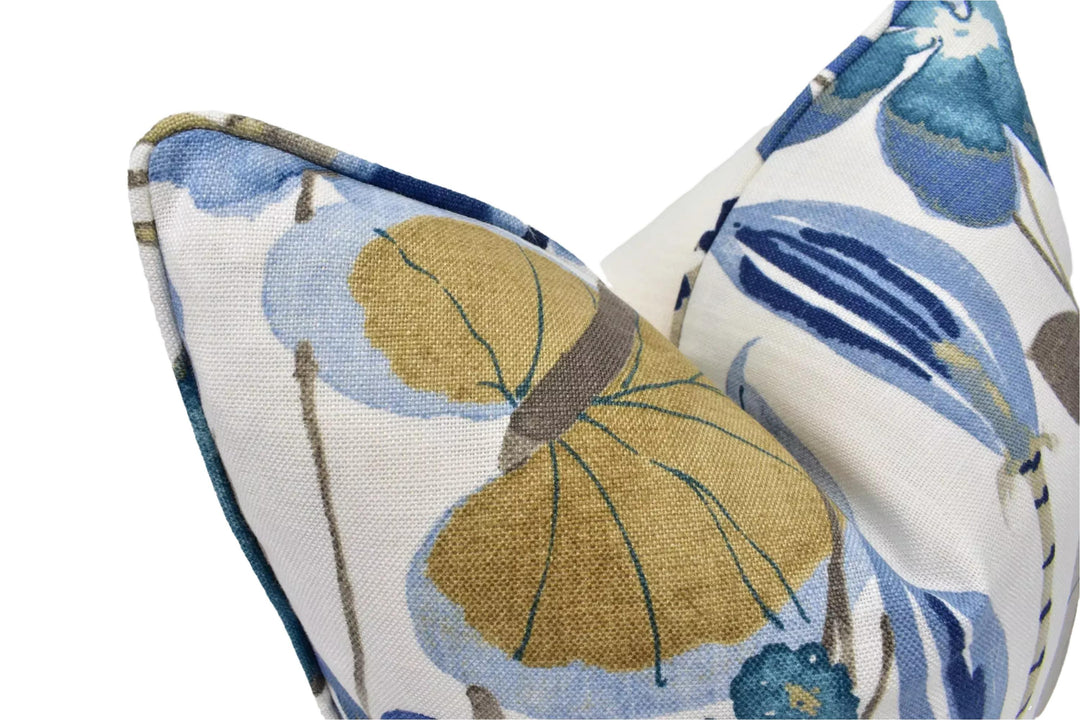 a close-up view of a decorative pillow with a blue and white floral pattern.