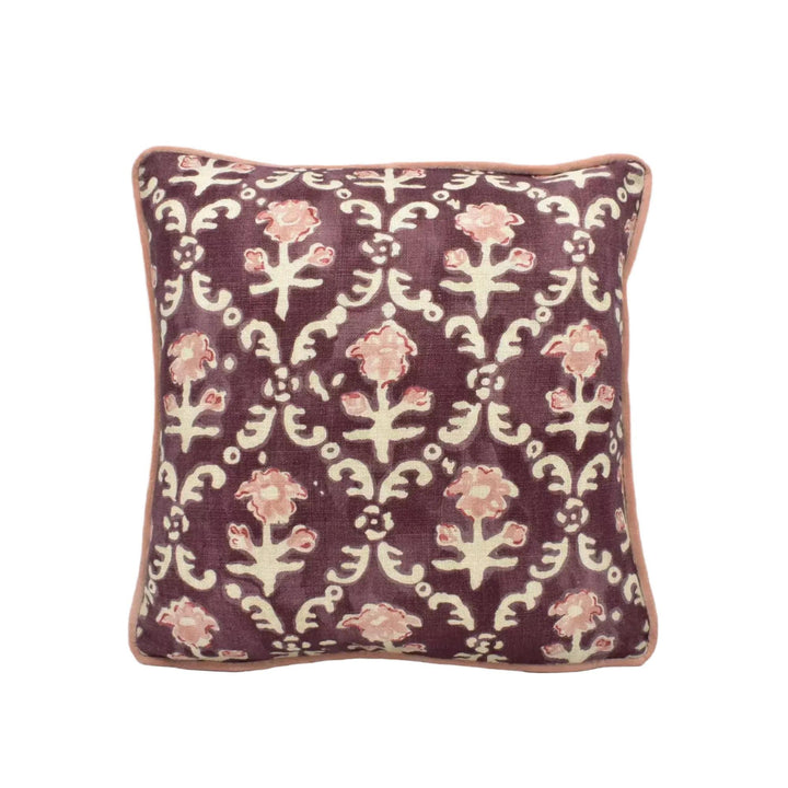 A square throw pillow with a floral pattern in shades of purple and white.