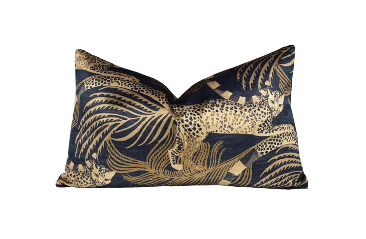 A decorative throw pillow with a gold and black leopard print design.