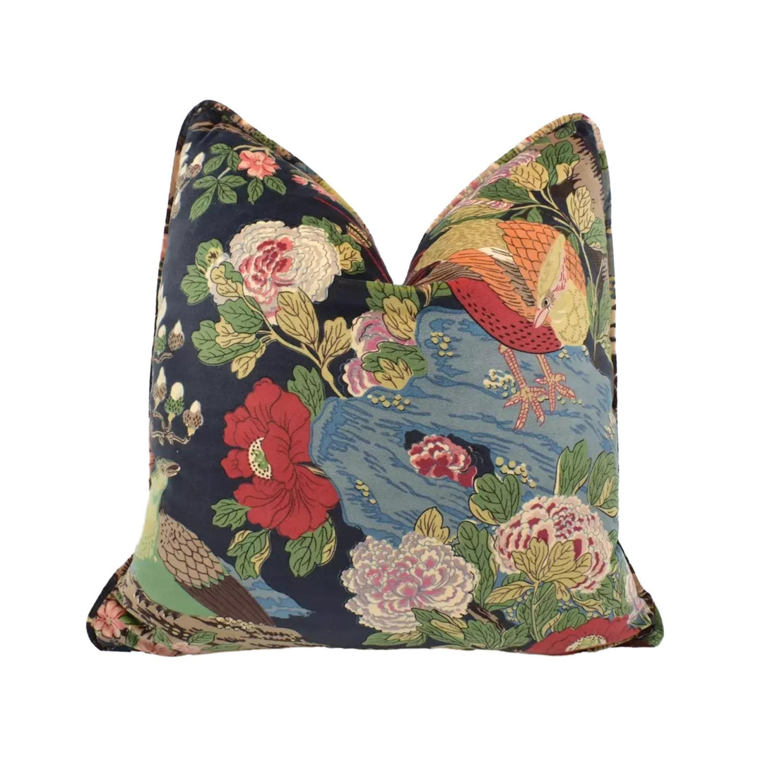 a vibrant, colorful pillow with a floral and bird motif.