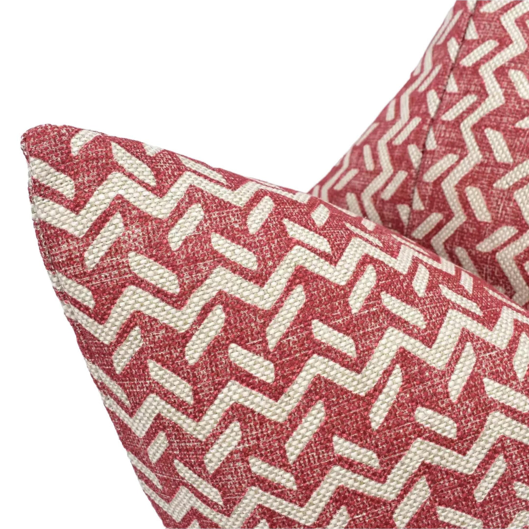 a close-up view of a red and white zigzag patterned pillow.