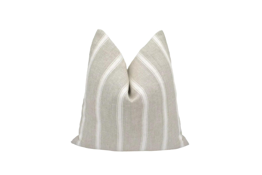 A beige and white striped pillow is placed against a white background.