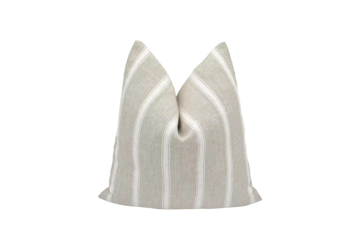 A beige and white striped pillow is placed against a white background.