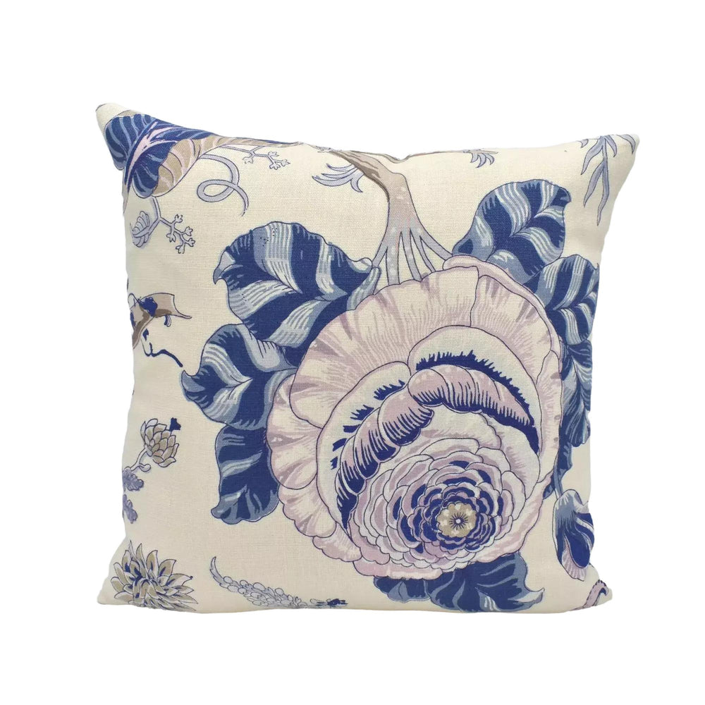 A decorative throw pillow with a floral pattern in shades of blue and white.
