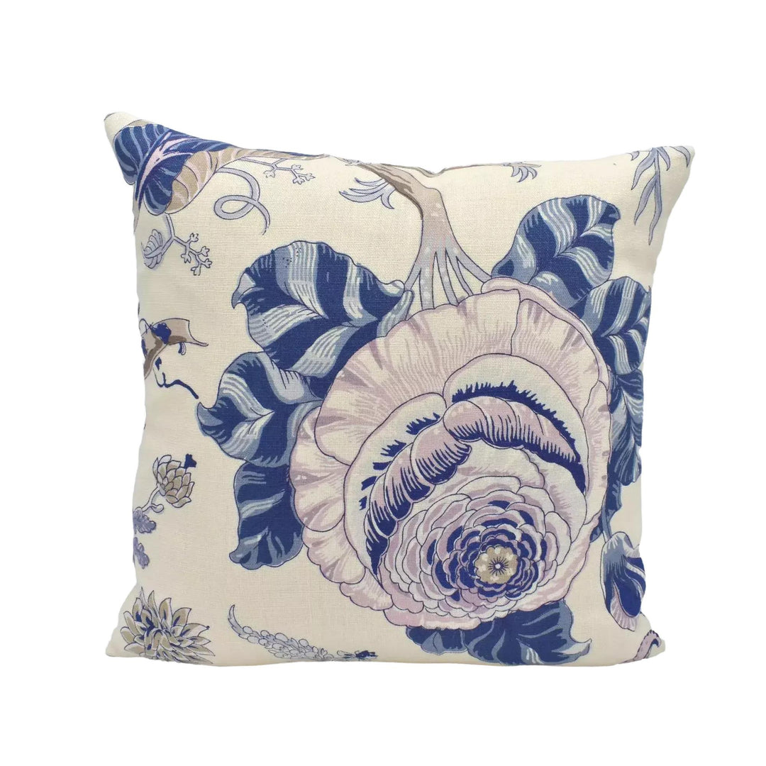 A decorative throw pillow with a floral pattern in shades of blue and white.