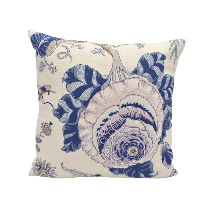 A decorative throw pillow with a floral pattern in shades of blue and white.