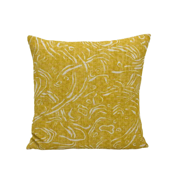 A square throw pillow with a yellow floral print pattern.