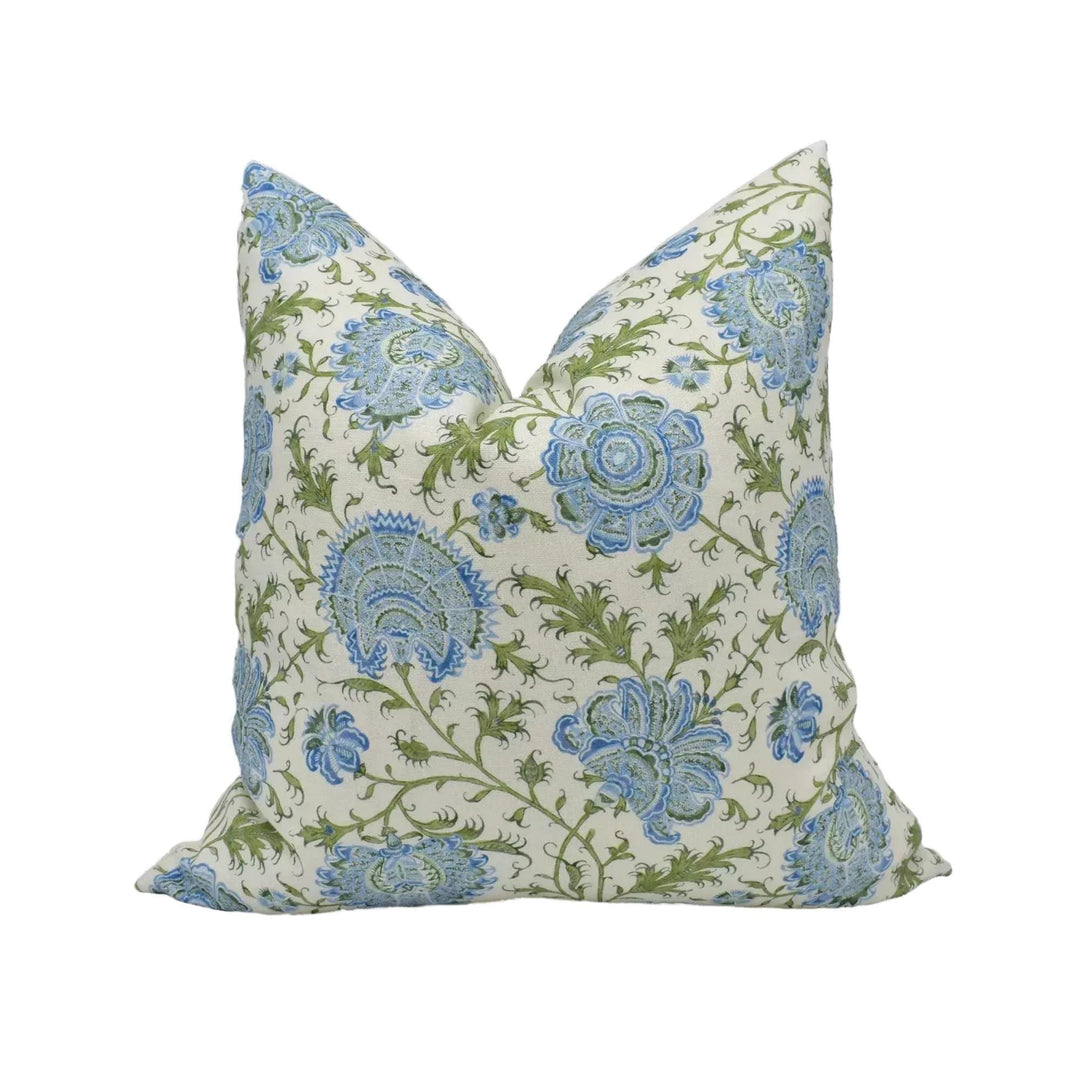 A decorative throw pillow with a floral pattern in shades of blue and green.
