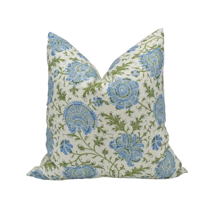 A decorative throw pillow with a floral pattern in shades of blue and green.