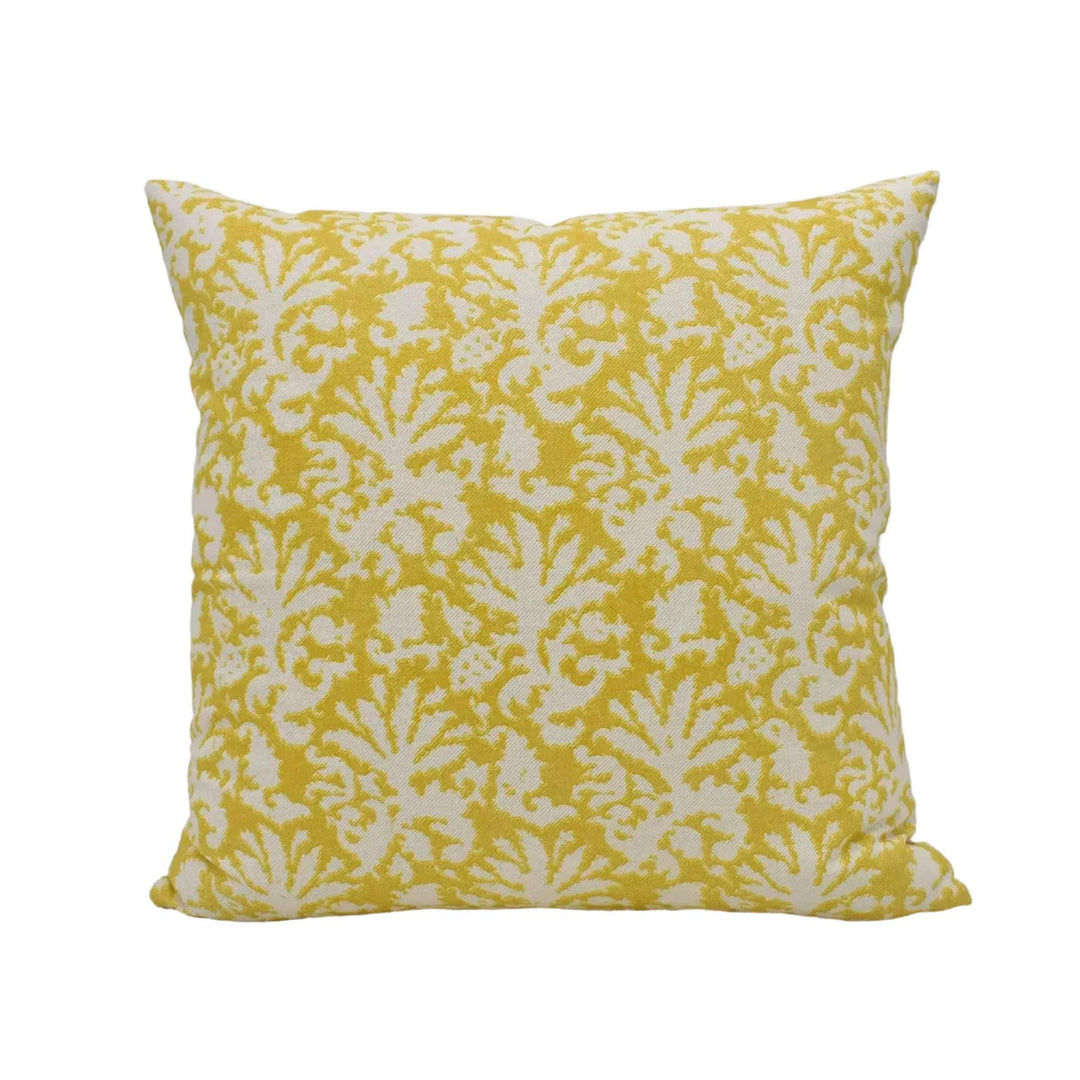 A square throw pillow with a yellow and white floral pattern.