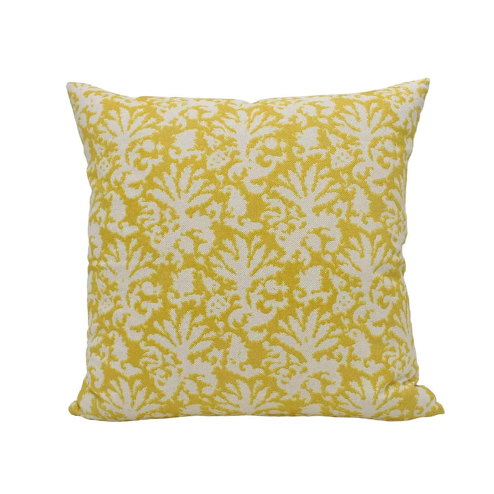 A square throw pillow with a yellow and white floral pattern.